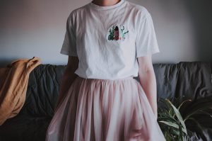 Girl in Minunki T-shirt and pink tulle dress.