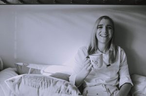 Black and white photo of girl with mug