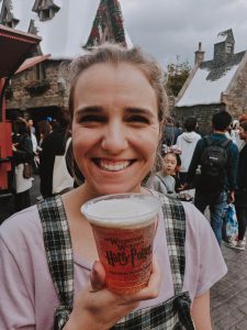 Girl holding butterbeer.