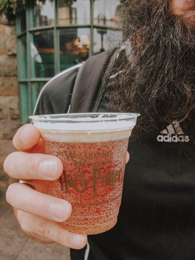 Hand holding butterbeer.