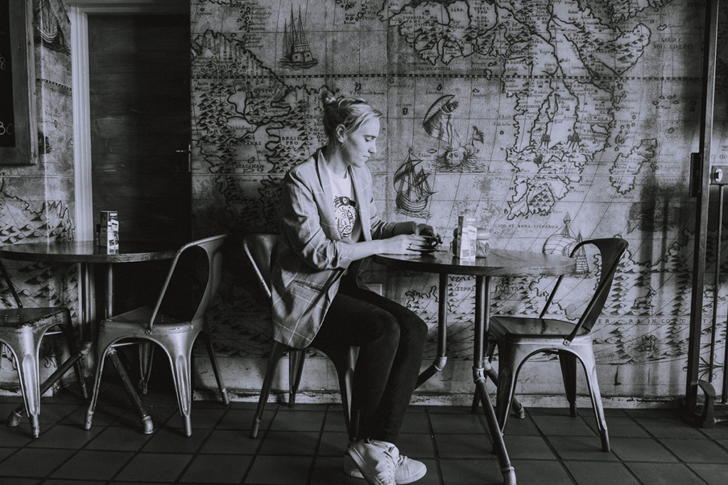 Girl sitting in coffee shop in Simonstad.