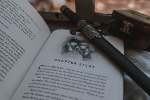 The Iron Trial open at Chapter Eight with dagger on top of it.