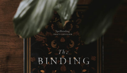 The cover of Bridget Collins' book, The Binding with a leaf over it.